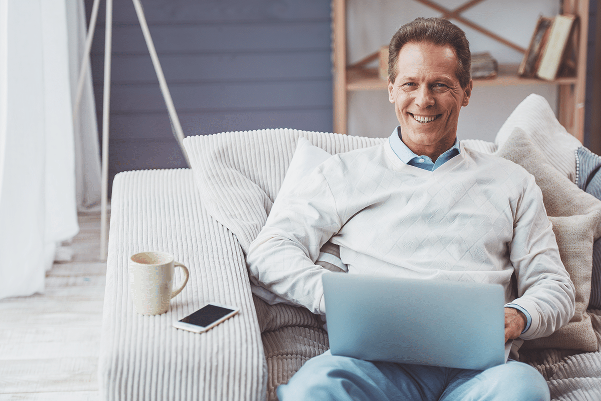 man on computer smiling