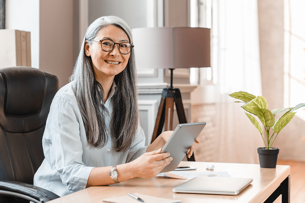 woman holding ipad learning about the benefits of working in the federal government