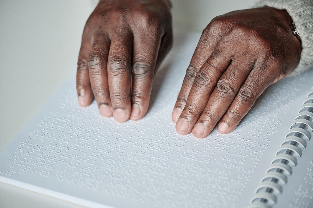 working while totally disabled, person reading braille