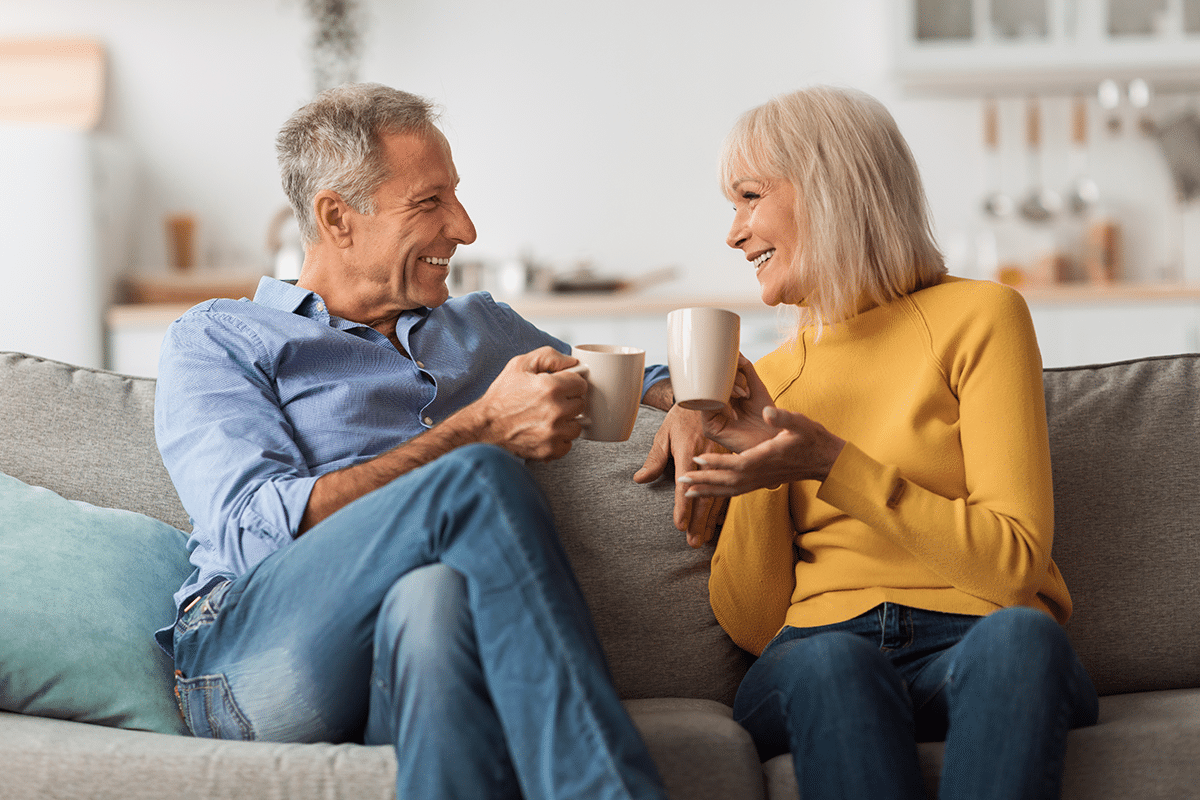 happy couple on couch with no retirement problems